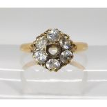 An 18ct gold diamond flower ring (one diamond missing) estimated approx diamond content 0.70cts,