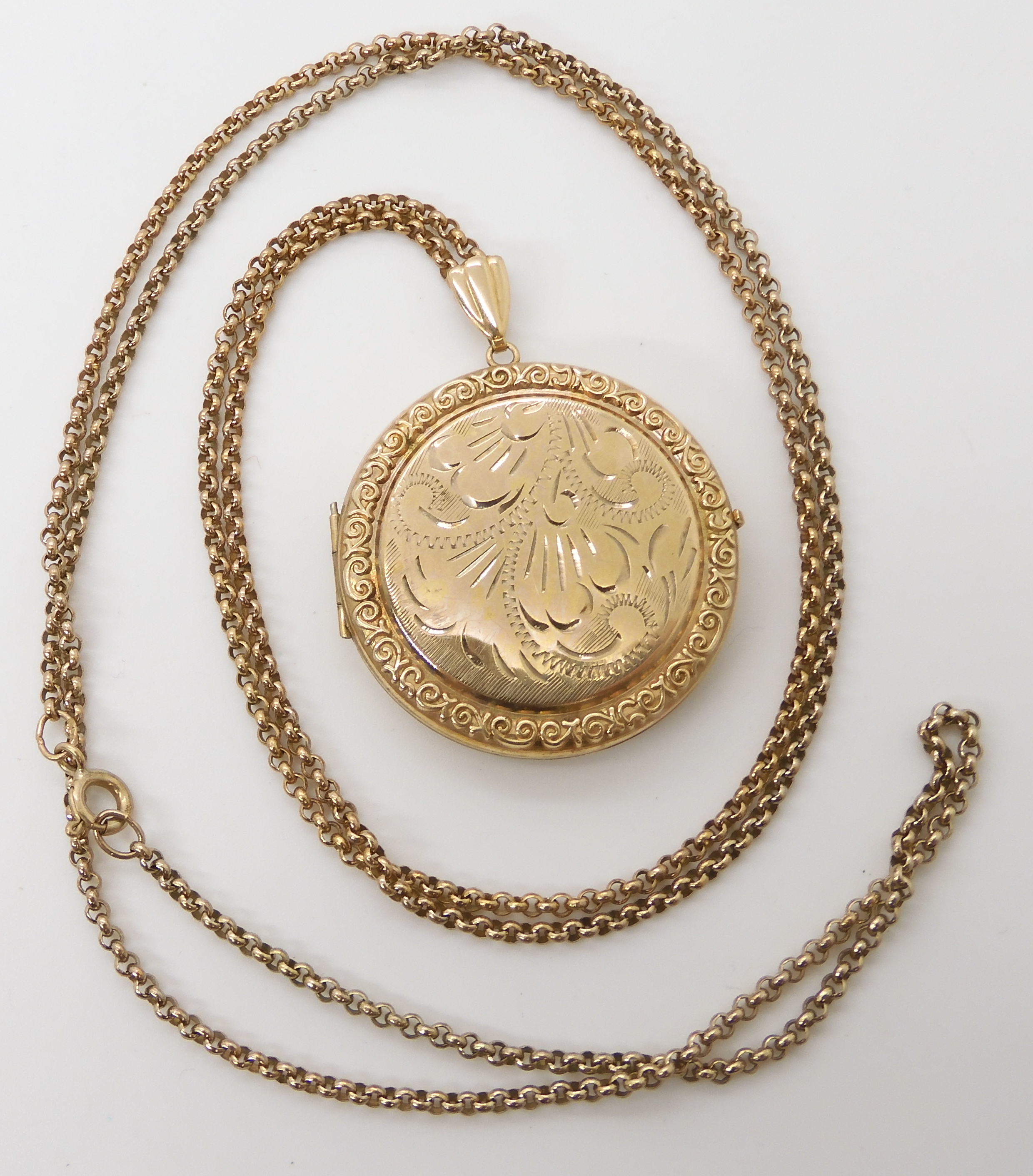 A 9ct circular locket diameter 3.5cm, with a 9ct gold chain length 76cm, weight combined 16gms