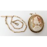 A large shell cameo of a grape picker in a locket back yellow metal mount, dimensions 5.5cm x 4.7cm,