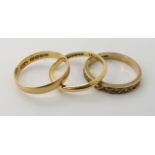 An 18ct gold Glasgow hallmarked wedding ring 1894, size P, together with another example, size O1/2,