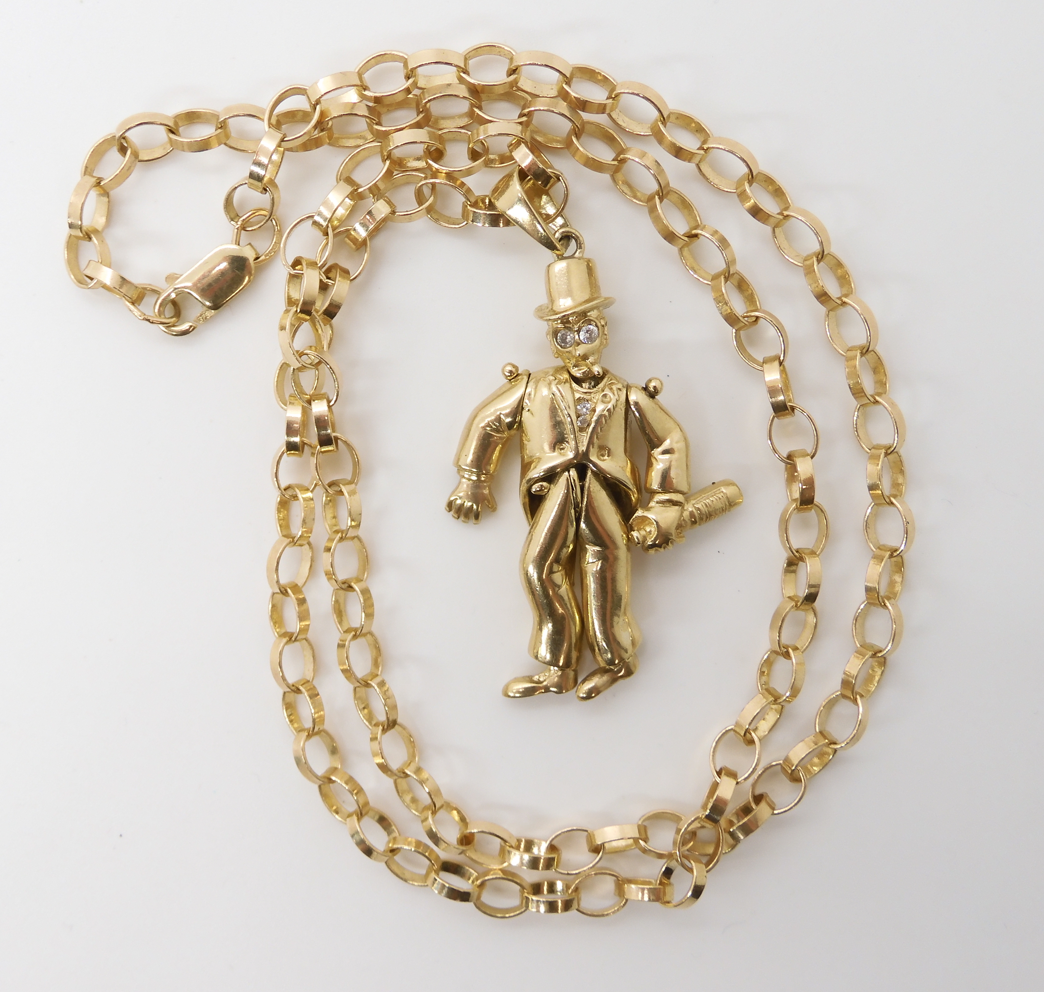 A 9ct gold pendant depicting a tipsy gentleman length 5.5cm, with unusual 9ct gold belcher chain