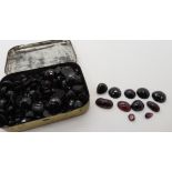 a box full of garnet cabochons, facet cut stones and carbunkles etc Condition Report: Not