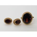 A 9ct gold garnet ring size J, with matching earrings weight 5.3gms Condition Report: Light