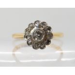 An 18ct gold and platinum diamond flower ring set with estimated approx 0.30cts, size M, weight 2gms