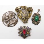 A white metal Art Nouveau style brooch set with gems, a further Art Nouveau buckle half, a
