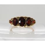 A 9ct gold five garnet set ring, size O1/2, weight 3.3gms Condition Report: Light general wear.