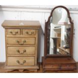 A miniature chest of drawers, 49cm high x 35cm wide x 22cm deep and a toilet mirror (2) Condition
