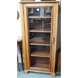 An oak bookcase with single glazed door, 148cm high x 71cm wide x 36cm deep Condition Report: