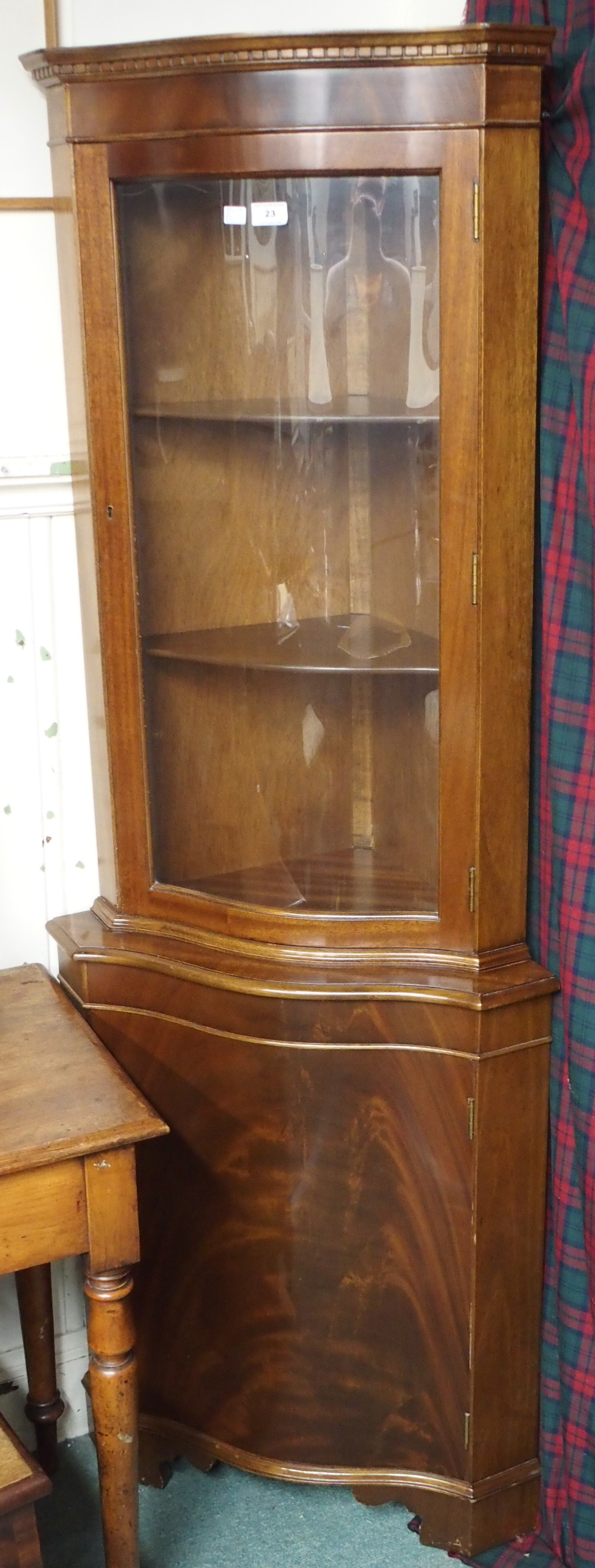 A mahogany serpentine front corner cabinet, 80cm high x 65cm wide x 57cm deep Condition Report: