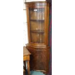 A mahogany serpentine front corner cabinet, 80cm high x 65cm wide x 57cm deep Condition Report: