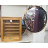 A small oak cabinet, 45cm high x 36cm wide x 14cm deep and a circular mirror (2) Condition Report: