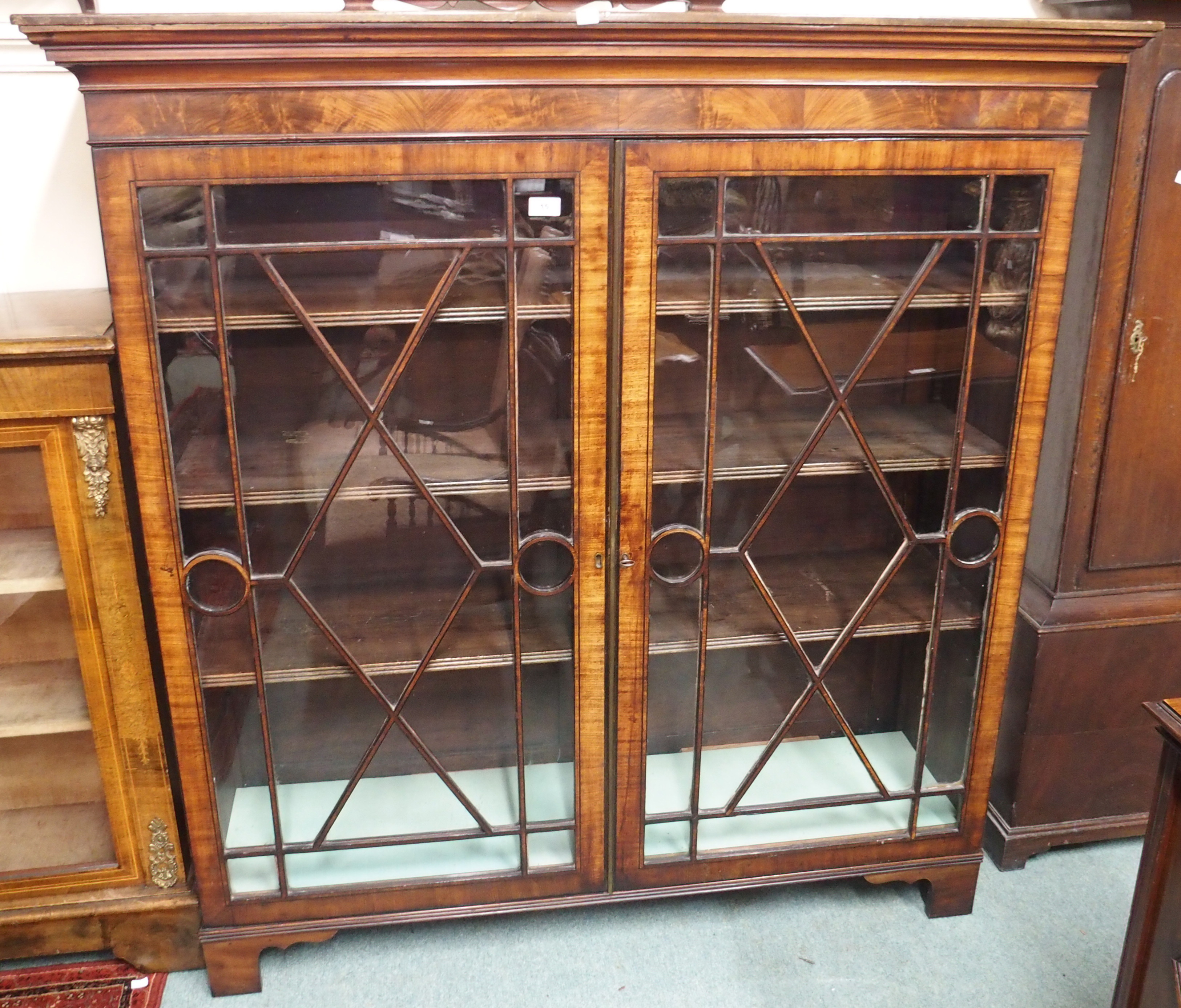 A mahogany bookcase with two glazed doors, 142cm high x 136cm wide x 40cm deep Condition Report: