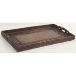 A Chinese hardwood carved tea tray decorated with dragons, geometric knot patterns and Shou