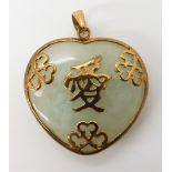 A yellow metal mounted heart shaped Chinese green hardstone pendant with Chinese symbols, dimensions