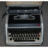 A portable Olivetti typewriter in carry case Condition Report: Available upon request