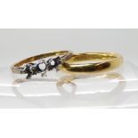 An 18ct gold court wedding ring size K1/2, together with an 18ct three stone ring blank size M,