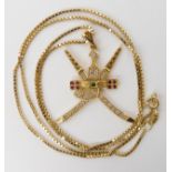 An 18k gold symbol of Oman pendant the crossed Swords and Khanjar set with diamonds, rubies and an