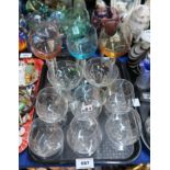 Six air twist wine glasses with coloured glass bowls, a set of six small brandy glasses etched