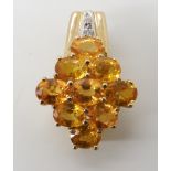 A 9ct gold yellow gemstone and diamond accent pendant, possibly yellow sapphires silk inclusions are