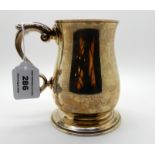A silver tankard, Birmingham 1965, of baluster form and scrolling handle, 12.5cm high, 393gms