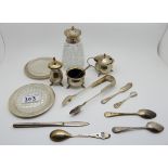 A lot comprising a silver cigarette box, a silver topped sugar castor, silver sugar tongs, silver