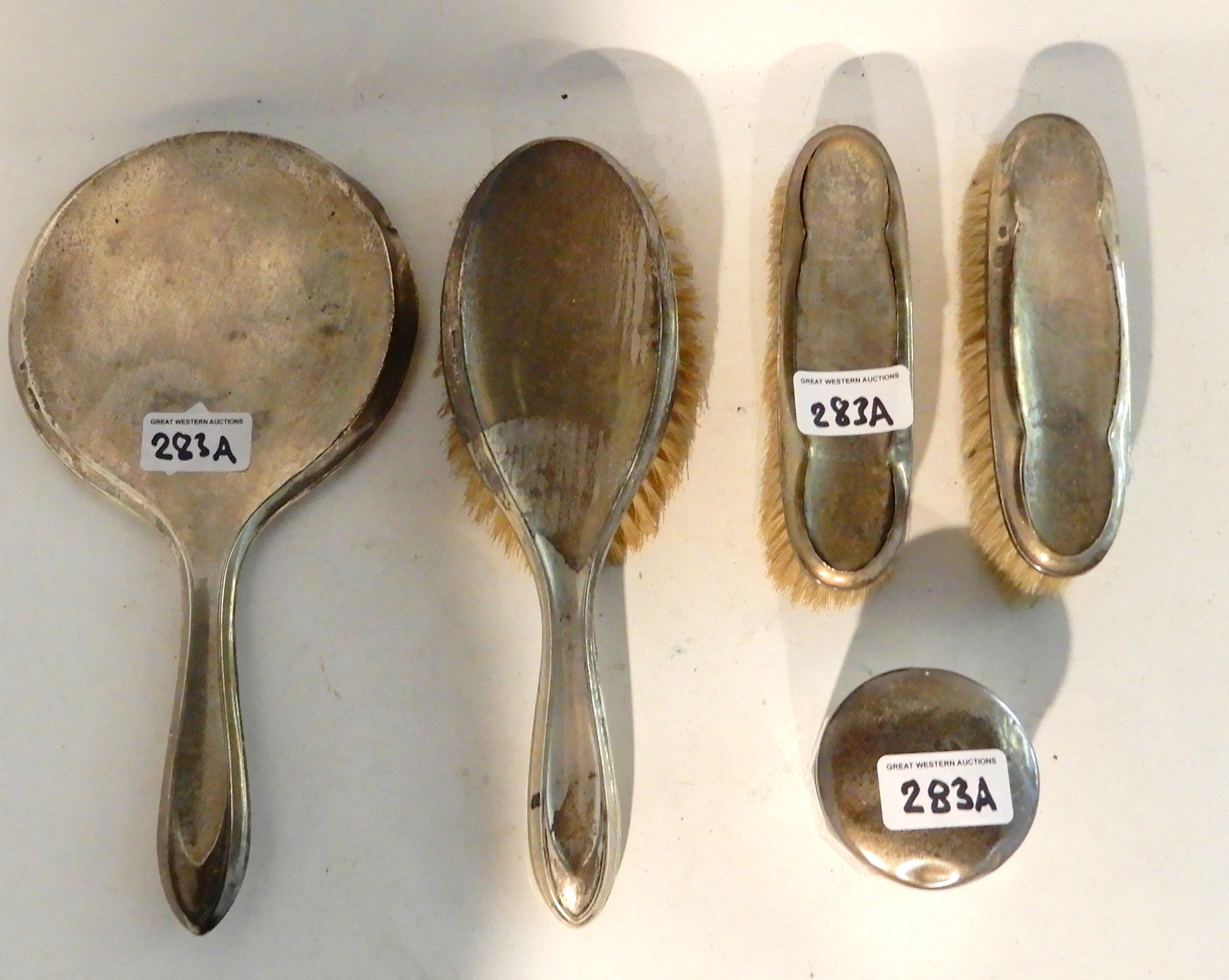 A lot comprising a four piece silver dressing table set, Chester 1918 and a silver topped jar