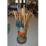 A collection of various walking canes etc in ceramic stick stand Condition Report: Available upon