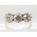 A 9ct yellow and white gold three stone diamond ring, set with estimated approx 1.30cts of brilliant