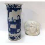 A Chinese blue and white cylinder vase and a white glazed face mask Condition Report: Available upon