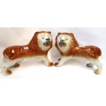 A pair of Scottish pottery lions (missing glass eyes) Condition Report: Available upon request