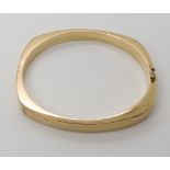 A 9ct gold bangle internal dimensions 6cm x 5.4cm, width 0.6cm, weight 15.6gms Condition Report: