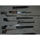 Five various bayonets, four in scabbards Condition Report: Available upon request