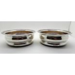 A pair of silver wine coasters, London 1900, of circular shape with gadrooned borders, 15cm in
