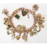 A 9ct gold curb link charm bracelet, hallmarked to every link, with eighteen attached charms to