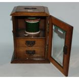 An Edwardian oak smoker cabinet, 27cm high Condition Report: Available upon request