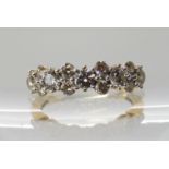 An 18ct gold diamond linear cluster ring set with thirteen brilliant cut diamonds with an