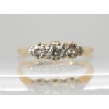 An 18ct and platinum three stone diamond ring of estimated approx 0.21cts, finger size H1/2,