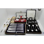 A lot comprising two cased sets of silver coffee spoons, two cased silver christening sets, a