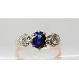 A sapphire and diamond three stone ring, the central sapphire is approx 5.6mm x 4.4mm x 3.8mm,