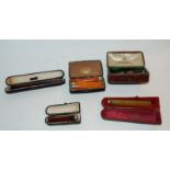 A collection of various cigarette holders, enamel badges etc Condition Report: Available upon