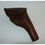 A brown leather gun holster, a collection of military buttons and enamel lapel badges etc