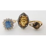 A 9ct gold blue and clear gem set ring size N1/2, a 9ct smoky quartz ring size L1/2, and a yellow