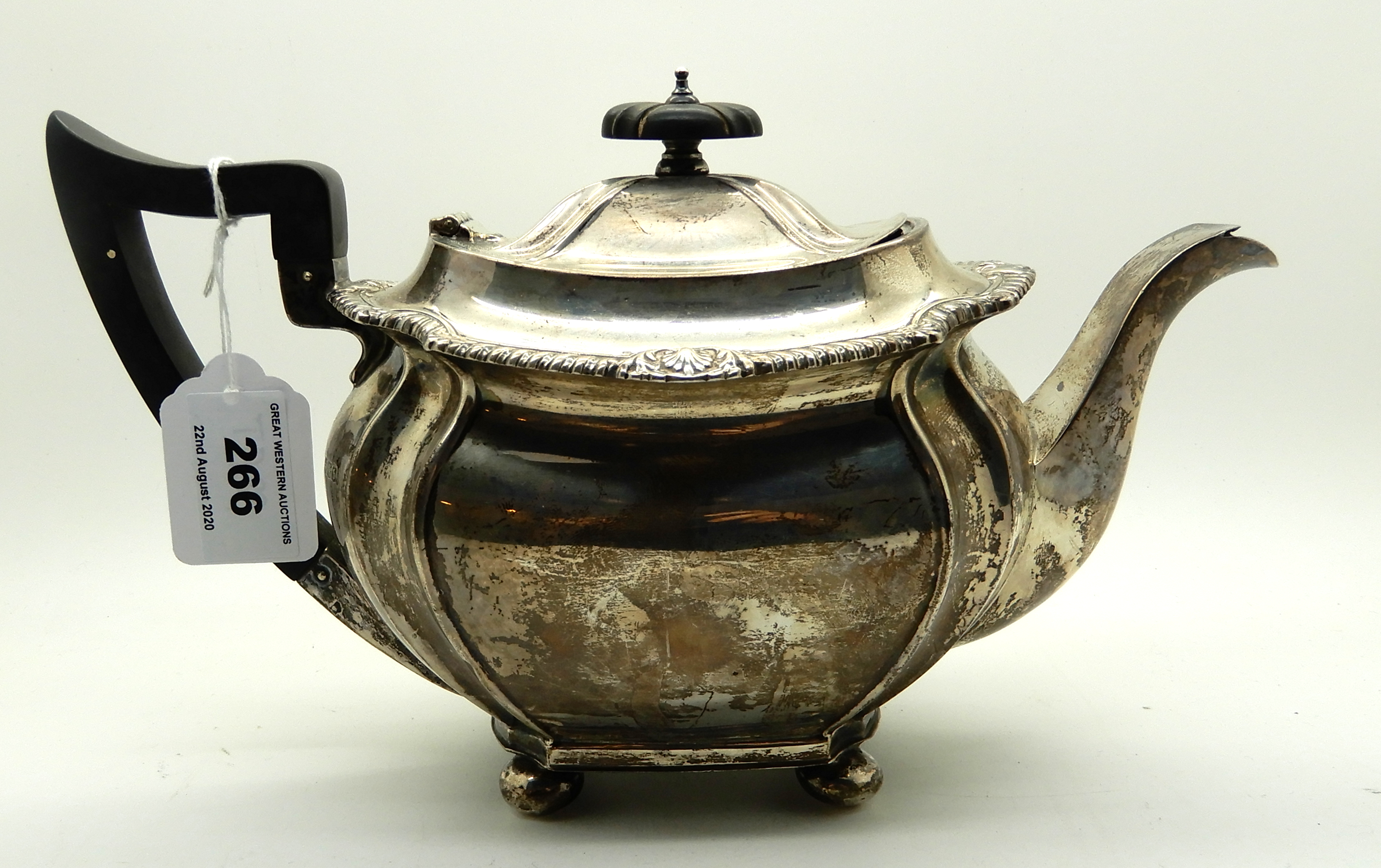 A silver teapot, Sheffield 1919, of rounded rectangular form and four ball feet, 16cm high, 704gms