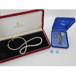 A string of cultured pearls in a Mikimoto box, a Siam butterfly pendant, a silver marcasite ring and