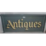 A painted Antiques advertising sign, 80 x 35cm Condition Report: Available upon request