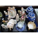 A pair of Chelsea style figures of a man and a woman, a small cherub mounted table mirror, a