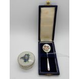 A lot comprising a cased silver and enamel spoon, Birmingham 1970 and a silver and floral enamel