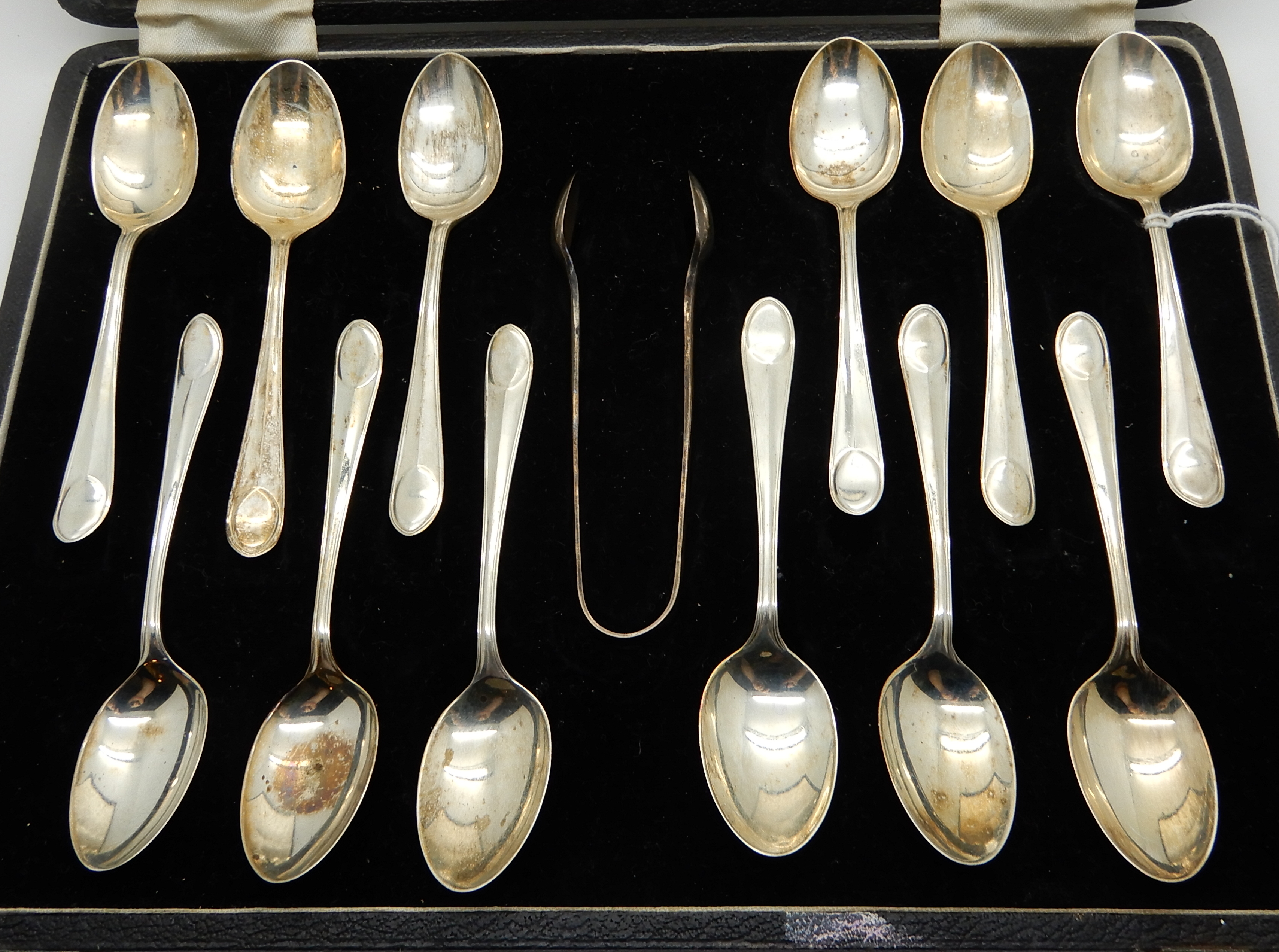 A cased set of twelve silver coffee spoons with tongs, Sheffield 1936 Condition Report: Available - Image 2 of 3