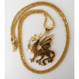 A bright yellow metal dragon pendant with a ruby eye, dimensions 4.5cm x 3.4cm, length of 18ct chain