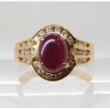 A 14k gold ruby cabochon and diamond ring, finger size Q, weight 5.1gms Condition Report: